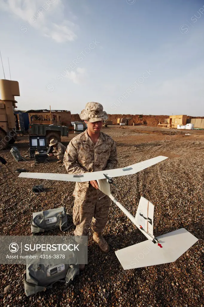 A U.S. Marine Prepares to Launch an Unmanned Aerial Vehicle (UAV) in Afghanistan's Helmand Province