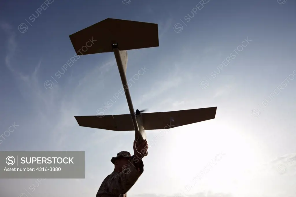 Silhouette of a U.S. Marine Preparing to Launch an Unmanned Aerial Vehicle (UAV) in Afghanistan's Helmand Province