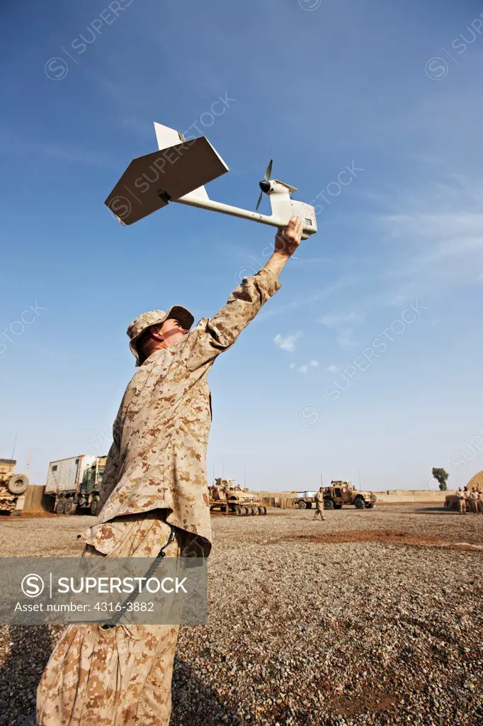 A U.S. Marine Demonstrates Launching an Unmanned Aerial Vehicle (UAV) at an Austere Combat Outpost in Afghanistan's Helmand Province