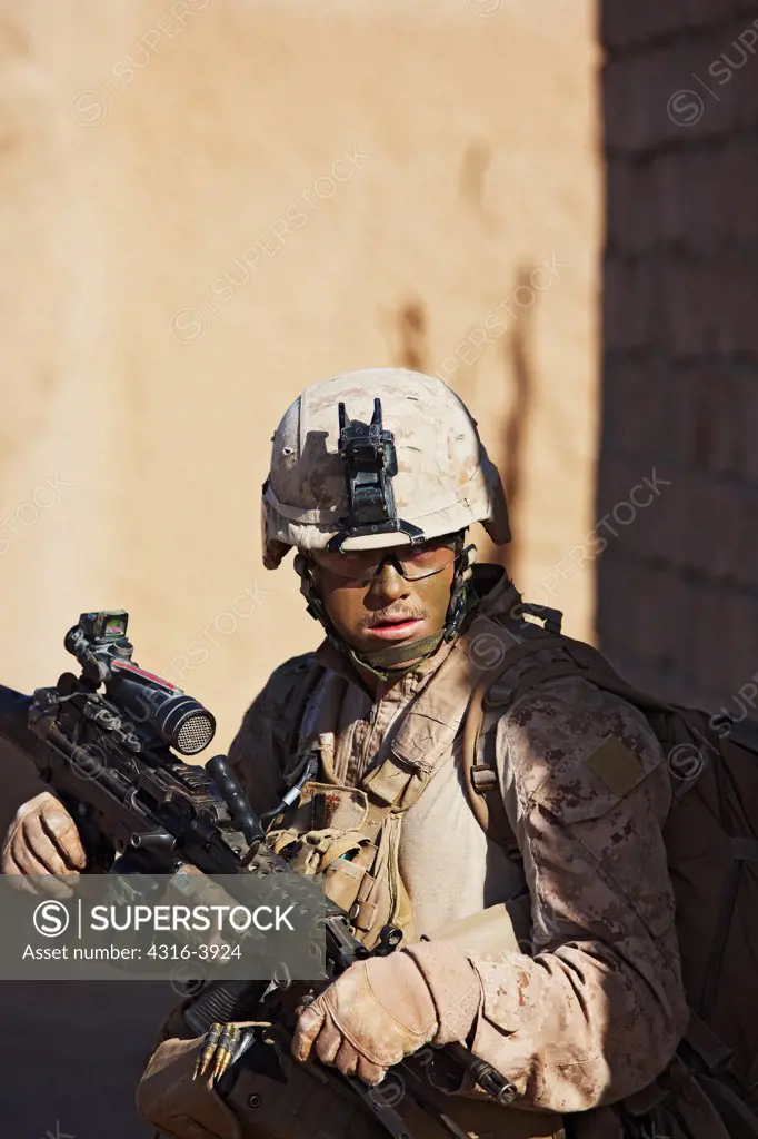 A U.S. Marine, Holding an M249 Squad Automatic Weapon, or SAW, During a Combat Operation in Afghanistan's Helmand Province