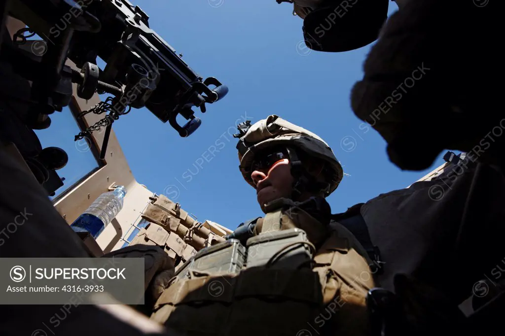 View of a U.S. Marine Turret Gunner in an M-ATV or Mine Resistant Ambush Protected All Terrain Vehicle, in Afghanistan's Helmand Province