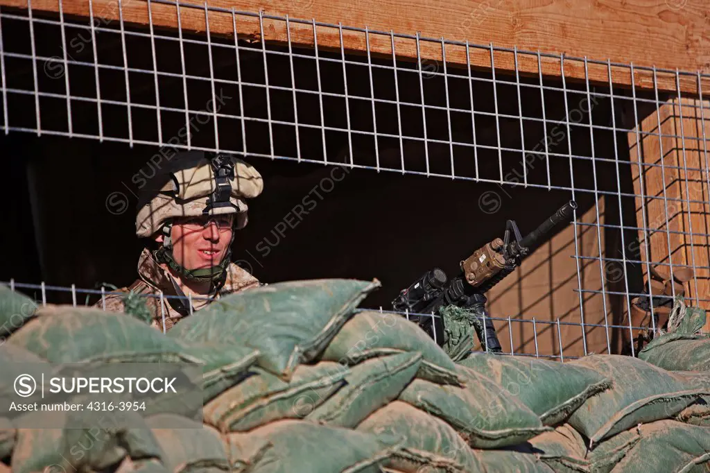 A U.S. Marine Standing Watch in a Guard Tower at a Forward Operating Base in the Town of Marjah, Helmand Province of Afghanistan