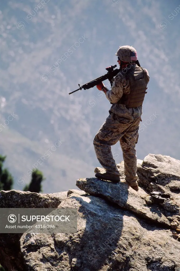 A US Marine Scans a Suspected Al Qaeda Camp Through the Site of an M-16 in the Foothills of Afghanistan's Hindu Kush Mountains