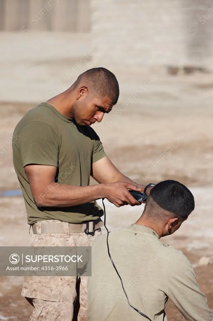 One U.S. Marine Gives Another a Haircut at a Small, Austere Combat Outpost in Afghanistan's Helmand Province