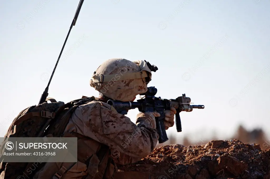 A U.S. Marine Aims His M4 Carbine During a Combat Operation in Afghanistan's Helmand Province