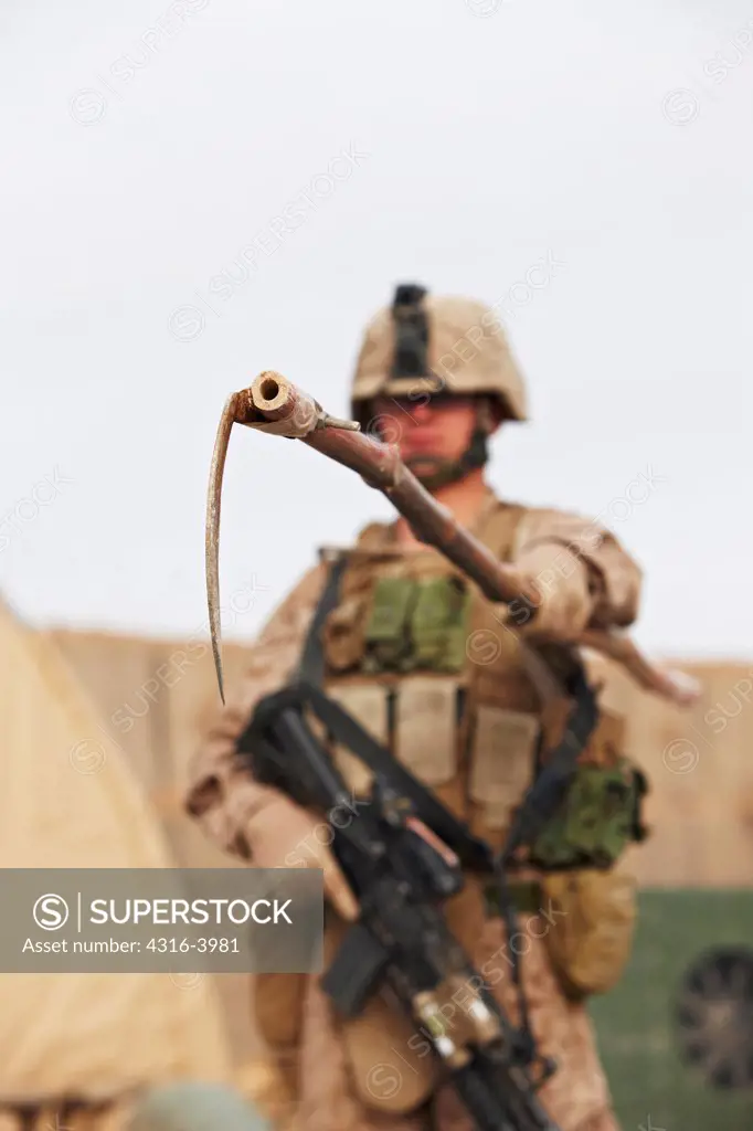 A U.S. Marine Holds a Device Used to Probe for Improvised Explosive Devices at a Combat Outpost in Afghanistan's Helmand Province
