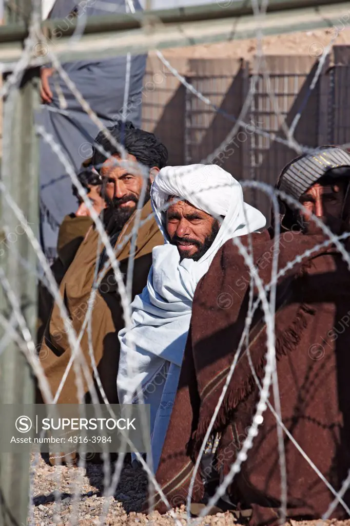 View Through Coils of Concertina Razor Wire of Men at a U.S. Marine Corps Combat Outpost in Afghanistan's Helmand Province