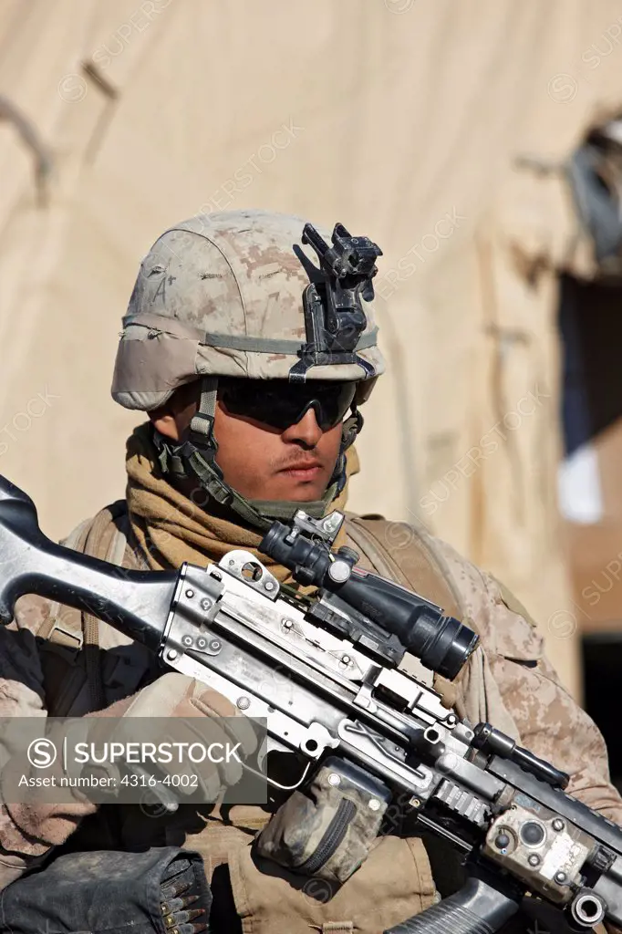 A U.S. Marine Holding an M249 Squad Automatic Weapon, or SAW, at a Small Combat Outpost in Afghanistan's Helmand Province