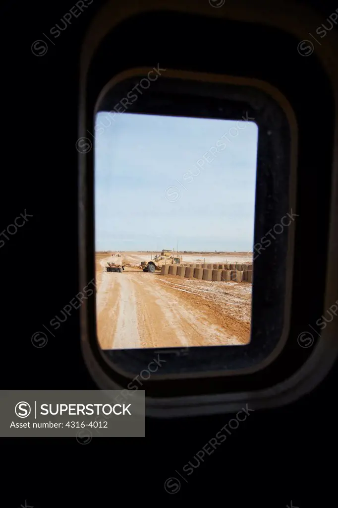 View Through Small Bullet Proof Glass Window of an MRAP, or Mine Resistant Ambush Protected Vehicle, at Another MRAP, With a Mine Roller, Helmand Province of Afghanistan