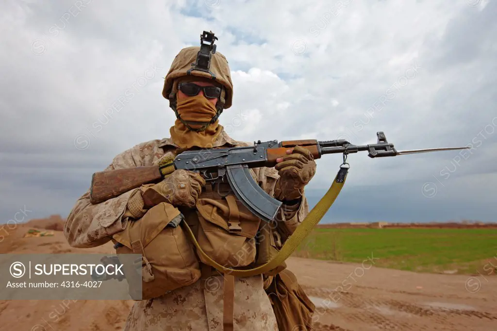 A U.S. Marine Poses With a Militia Fighter's AK47, Fitted With a Bayonet, at a Combat Outpost in Afghanistan's Helmand Province.
