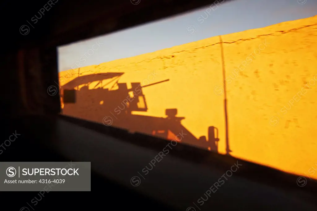 Shadow of a U.S. Marine Corps MRAP, or Mine Resistant Ambush Protected Vehicle at Sunrise in Afghanistan's Helmand Province
