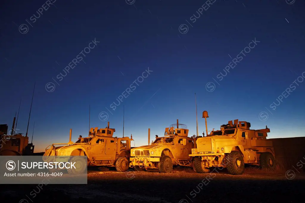 Late Dusk View of a Line of M-ATVs, or Mine Resistant Ambush Protected All Terrain Vehicles at a U.S. Marine Corps Combat Outpost in Afghanistan's Helmand Province