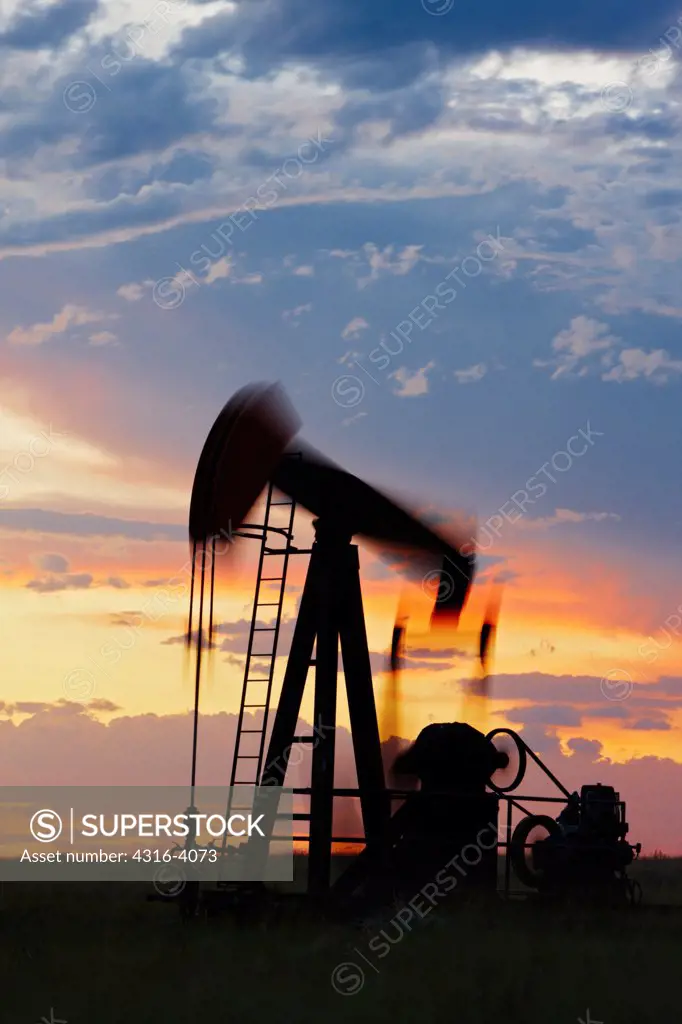 Oil Well Pump Jack at Sunset, Blurred Motion