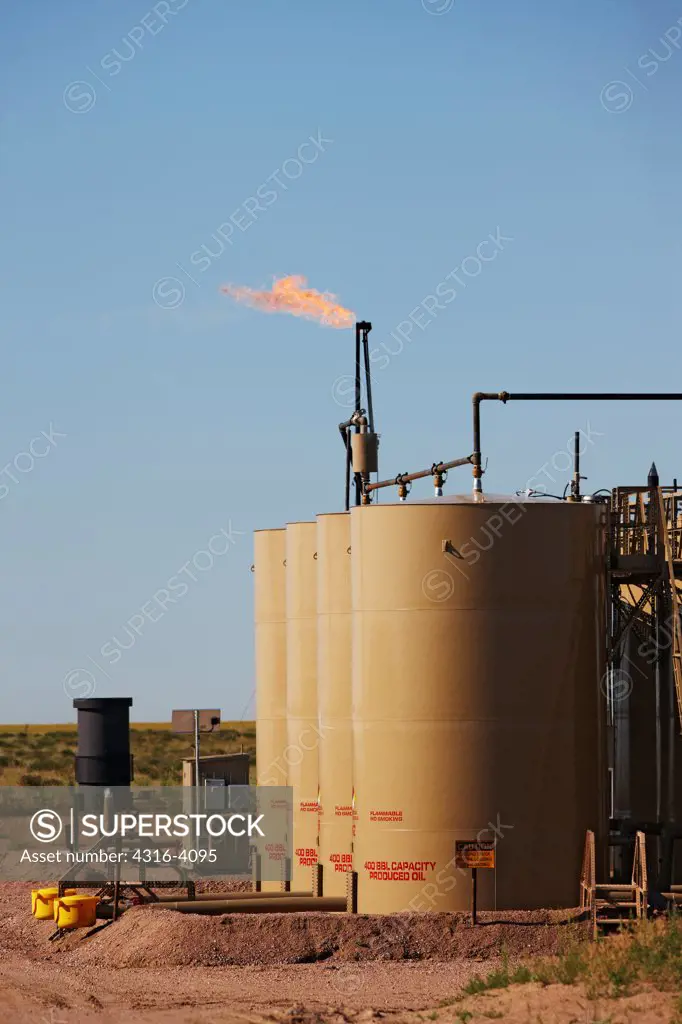 A Gas Flare And Crude Oil Storage Tanks
