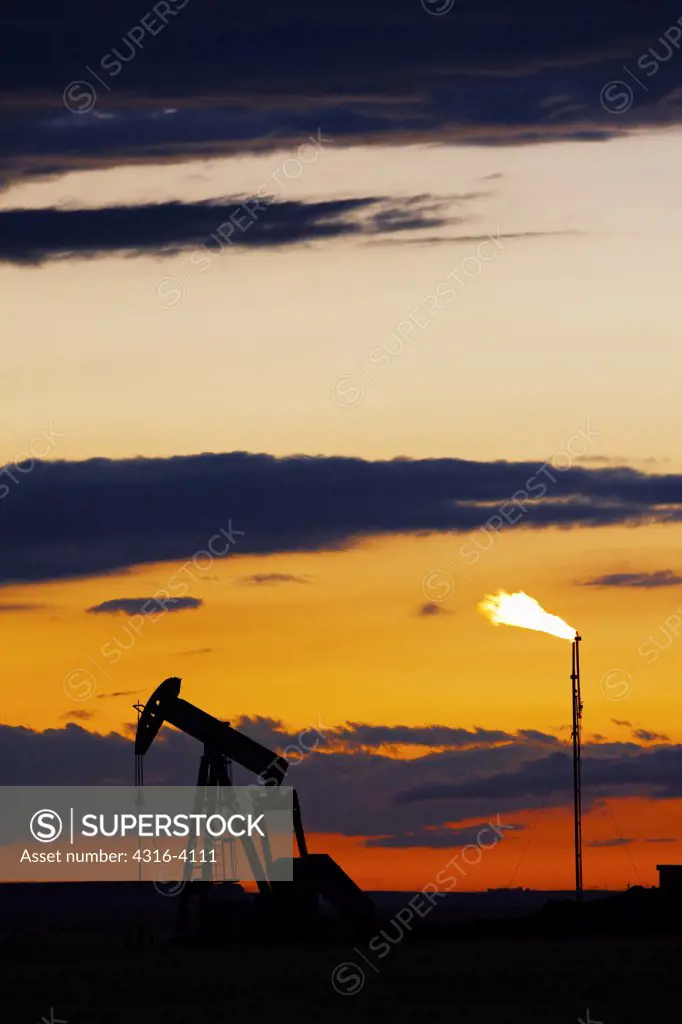 An Oil Well Pump Jack and Natural Gas Flare Tower