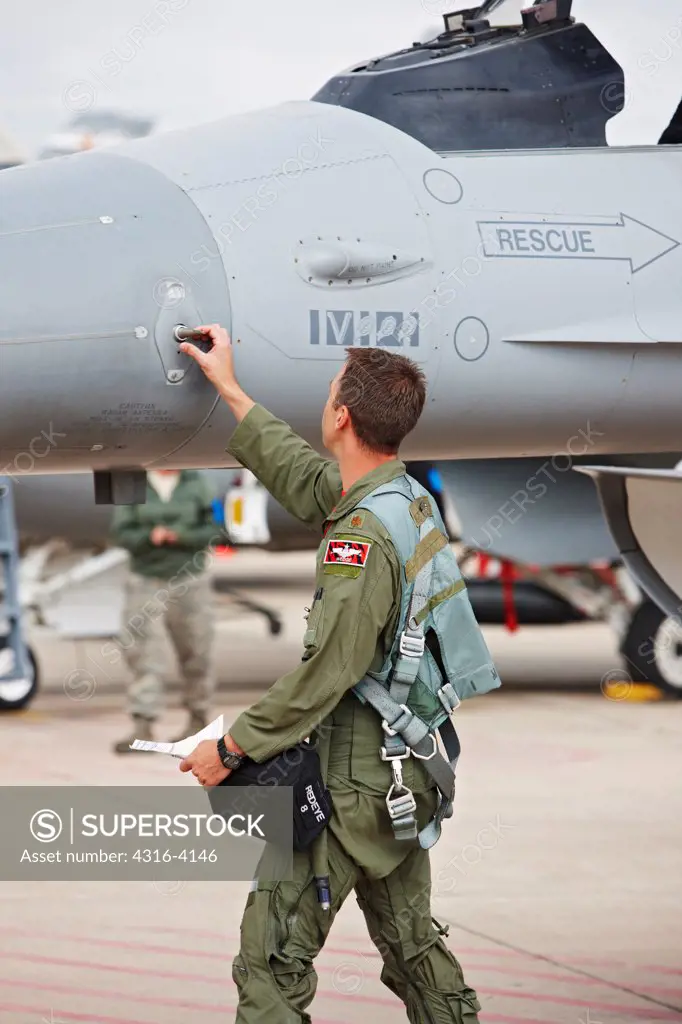 A Pilot Inspects an F-16 Before a Flight