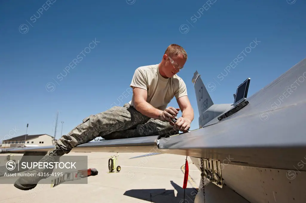 An Aircraft Maintainer Works on an F-16