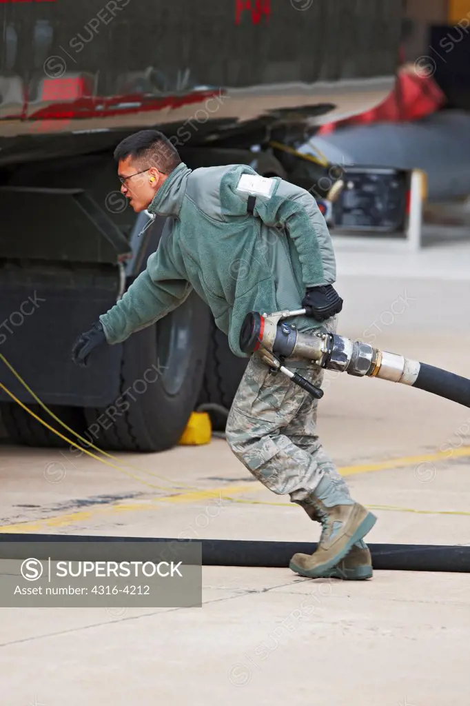 Crewman Pulls Fuel Hose to an F-16
