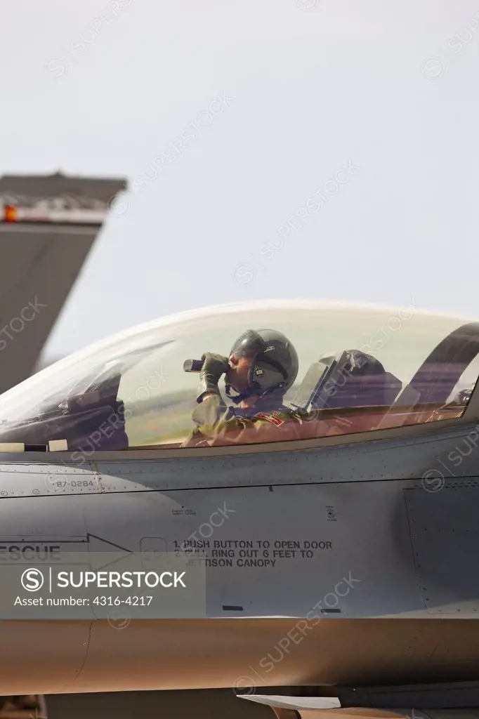 Pilot Drinks From a Water Bottle Before Launching an F-16