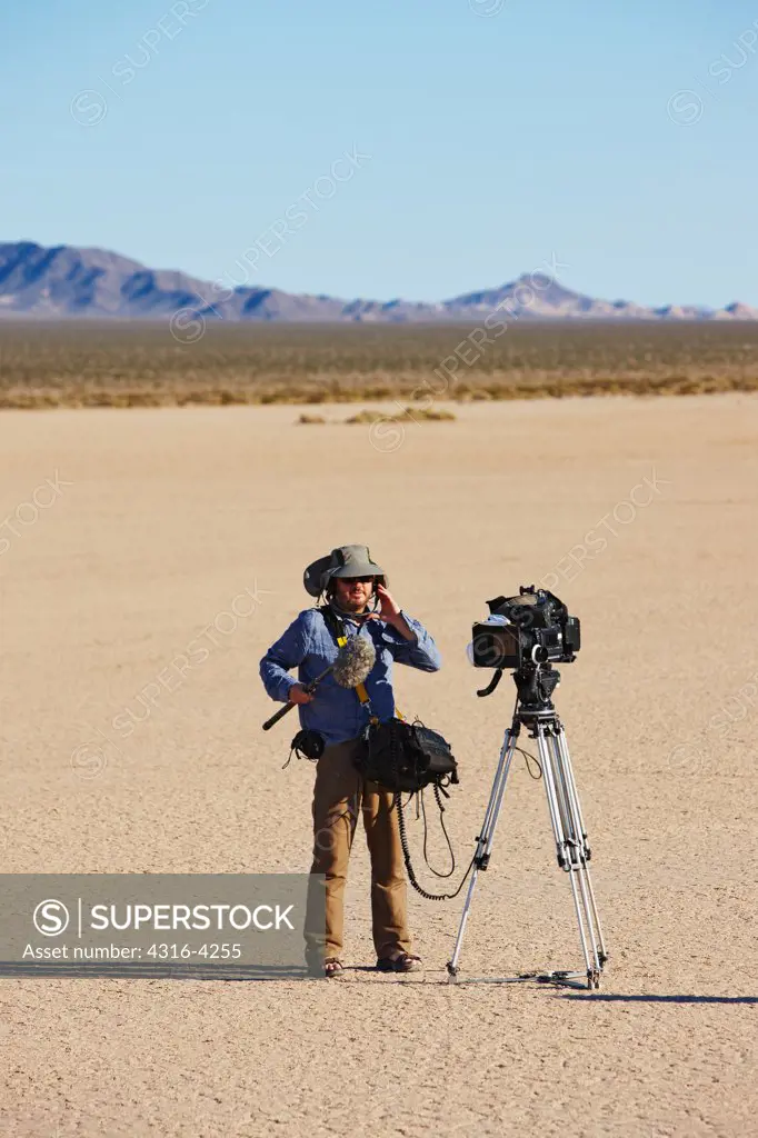 Sound Engineer and Professional Video Camera on Dry Desert Lake Bed