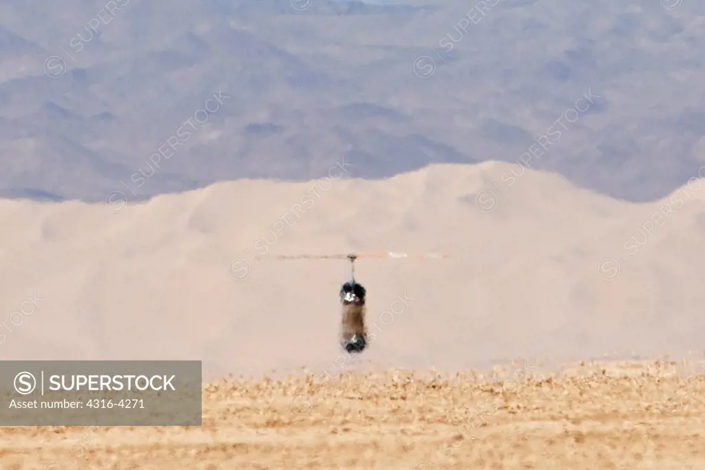 Helicopter and Distant Sand Dunes Visually Obscured By Inferior Mirage