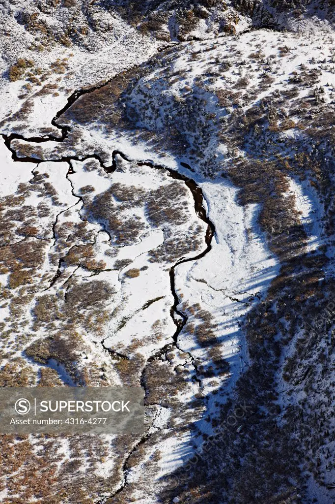 Aerial View of Stream in Mountains After Snow Storm