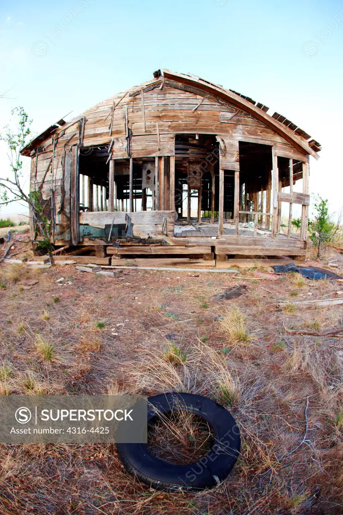 Old tire and abandoned ranch house, eastern plains of Colorado, USA