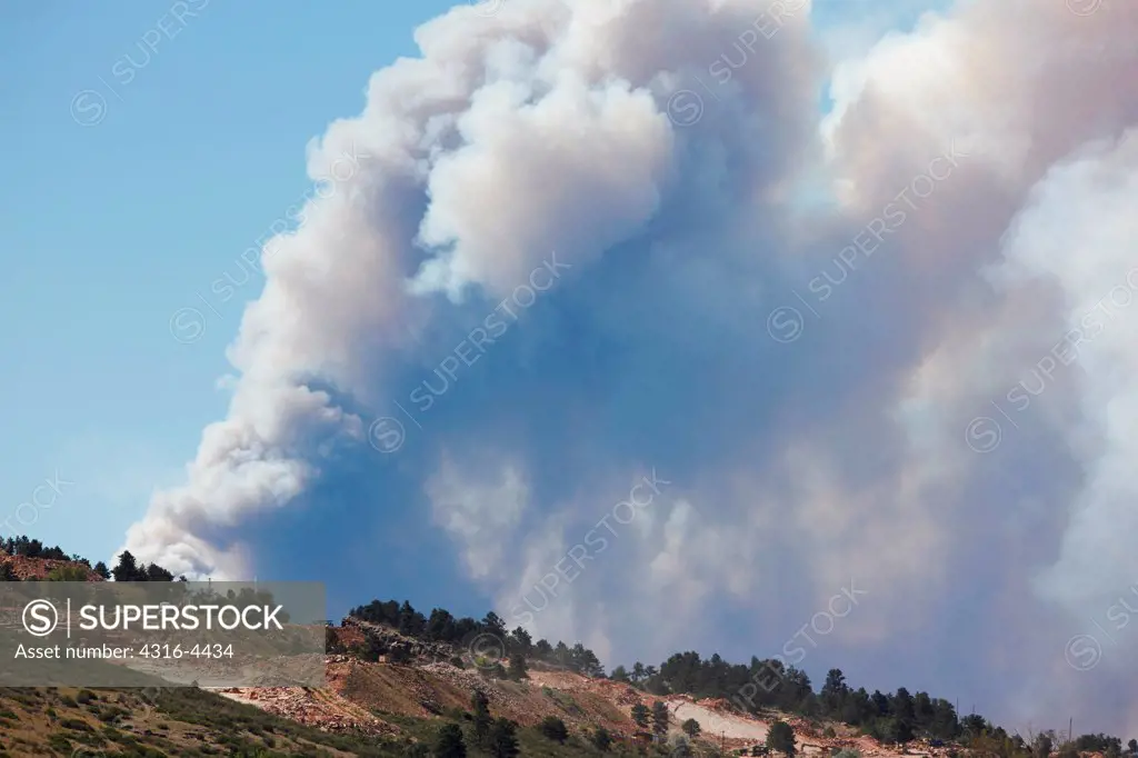 Raging mountain wildfire, rising smoke, northern Colorado, USA