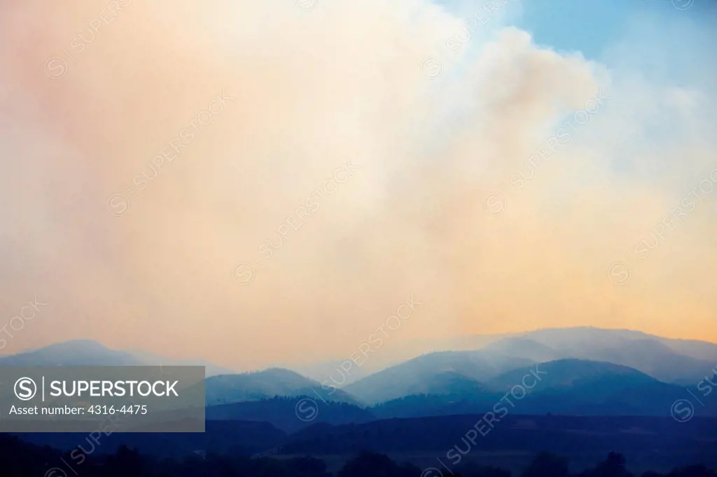 Ridges and mountains obscured by smoke from raging wildfire, northern Colorado, USA