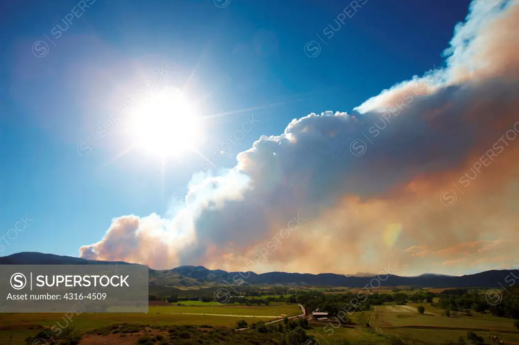 Plume of smoke rises from raging mountain wildfire, Colorado, USA