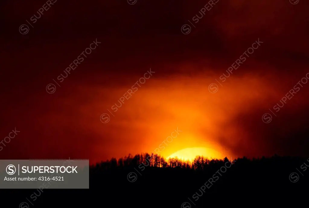Smoke from raging wildfire obscures setting sun, Colorado, USA