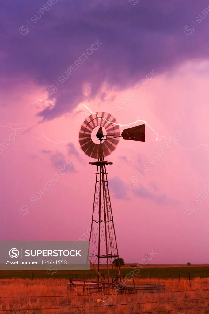 Lightning and lone windmill, eastern plains of Colorado, USA