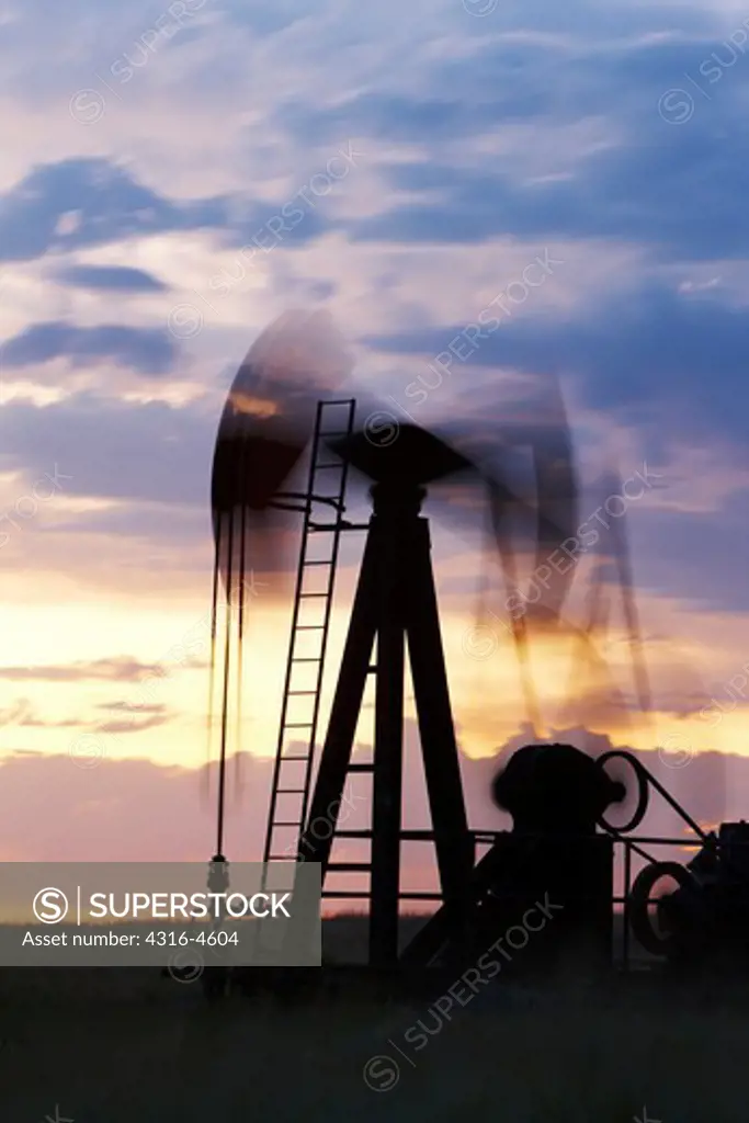 Oil well pump jack at work, blurred view