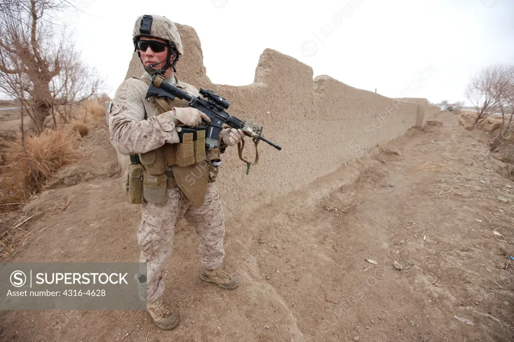 A United States Marine, holding an M4 Carbine, during a combat operation in Marjah, Helmand Province of Afghanistan