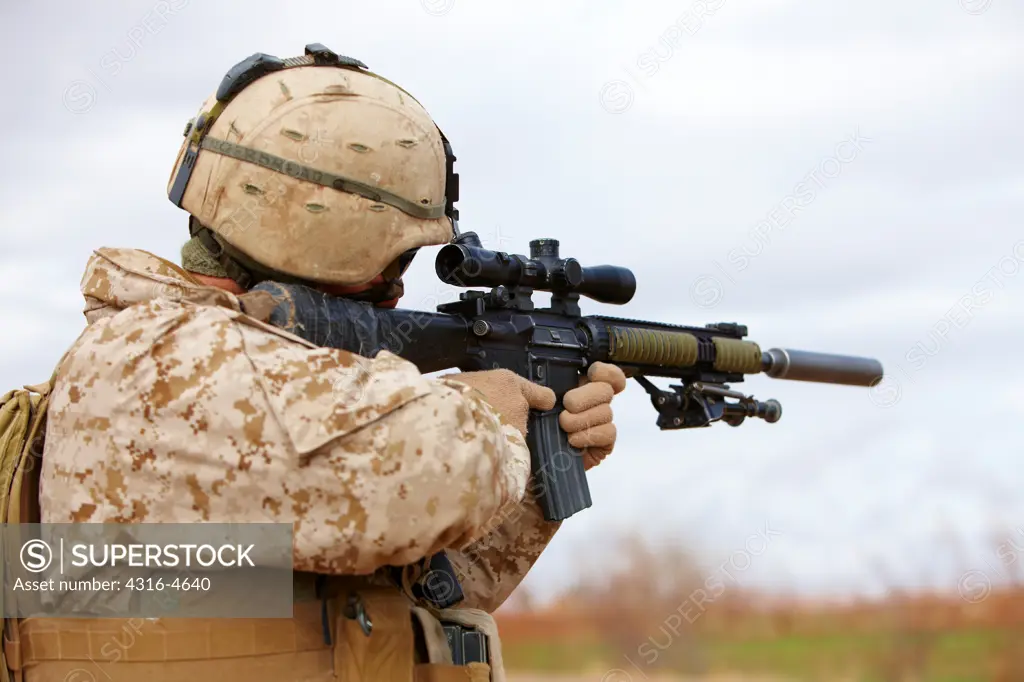 United States Marine aims a designated marksman rifle, Marjah, Afghanistan