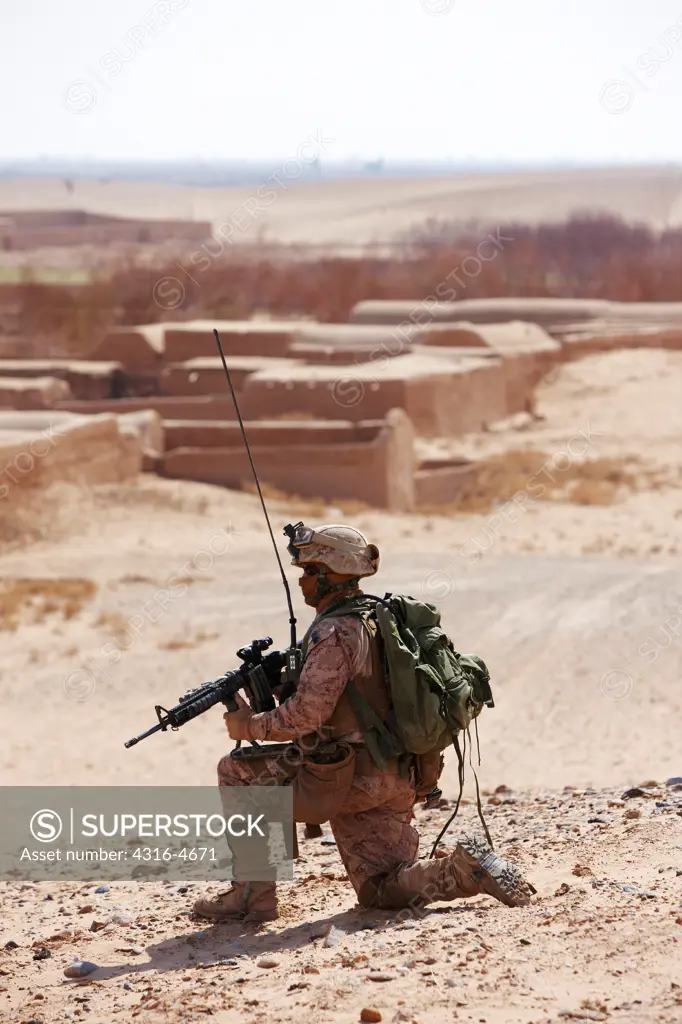 United States Marine with an M16 Rifle during a combat operation in Afghanistan's Helmand Province