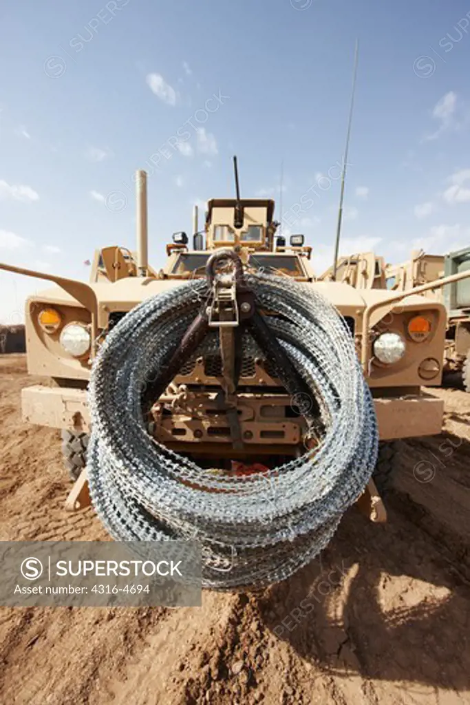 Concertina razor wire coiled on the front of a MAT-V at a small, remote, austere United States Marine Corps combat outpost in Afghanistan's Helmand Province