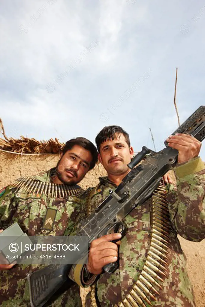 Afghan National Army soldiers show off an M240 medium machine gun and rounds for it, Helmand Province of Afghanistan
