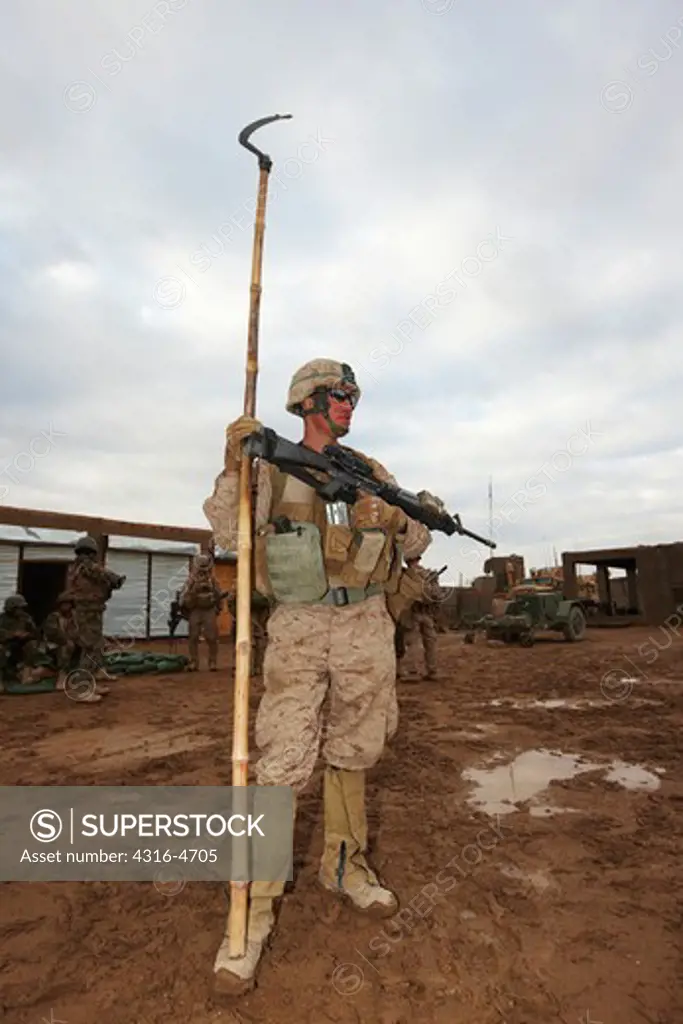 United States Marine with pole used to dig for hidden bombs and explosives, Helmand Province of Afghanistan
