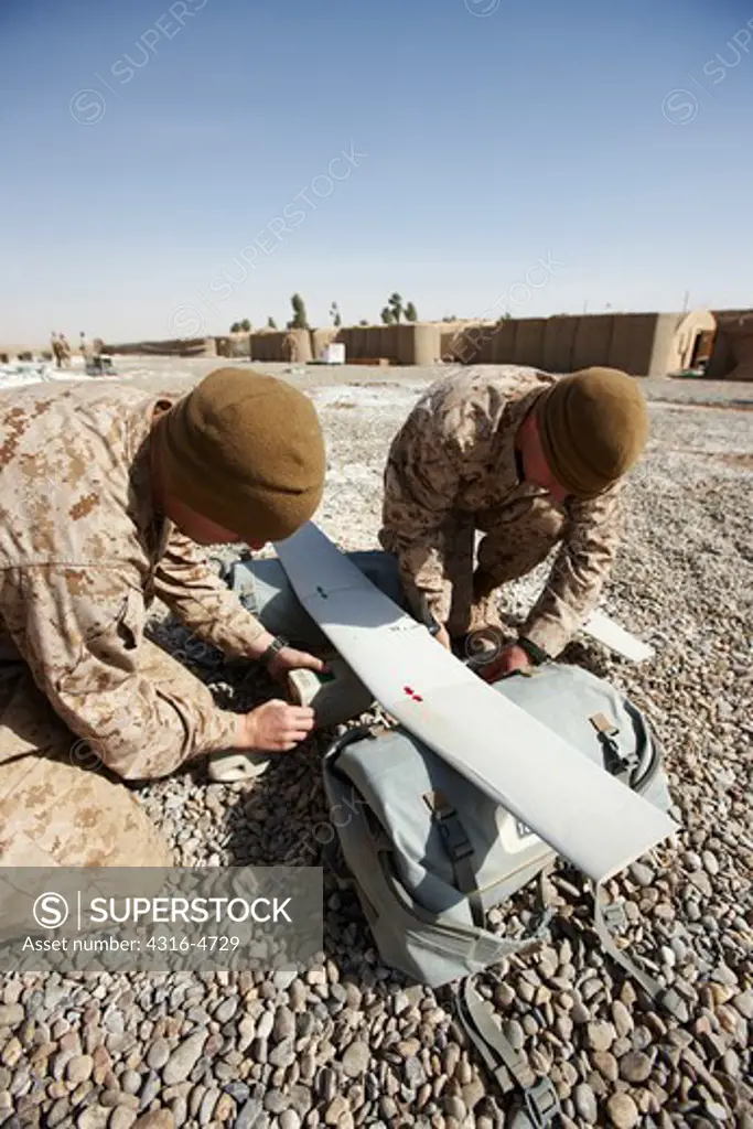 United States Marines assemble an Aerovironment RQ-11 Raven-B unmanned aerial vehicle at a forward operating base in Afghanistan's Helmand Province