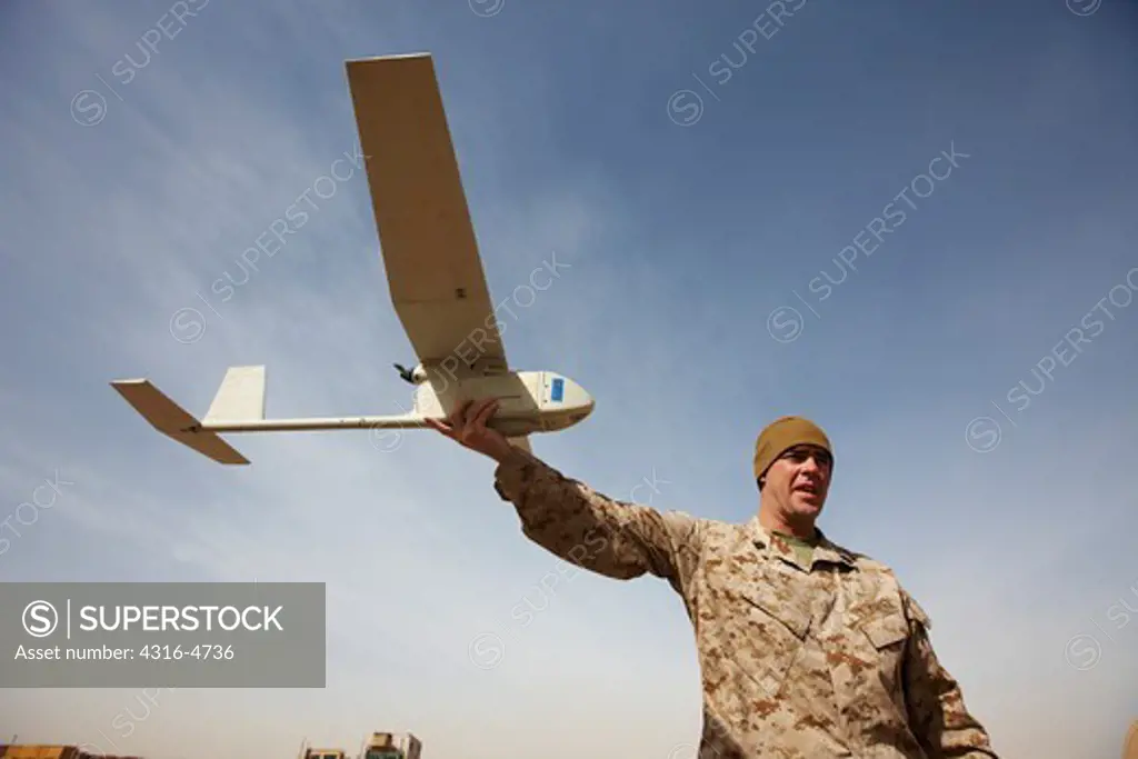 United States Marines assemble an Aerovironment RQ-11 Raven-B unmanned aerial vehicle at a forward operating base in Afghanistan's Helmand Province