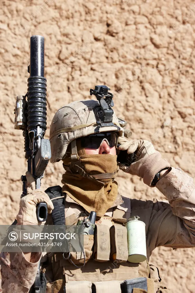 United States Marine speaks on a smartphone during a combat operation in Afghanistan's Helmand Province
