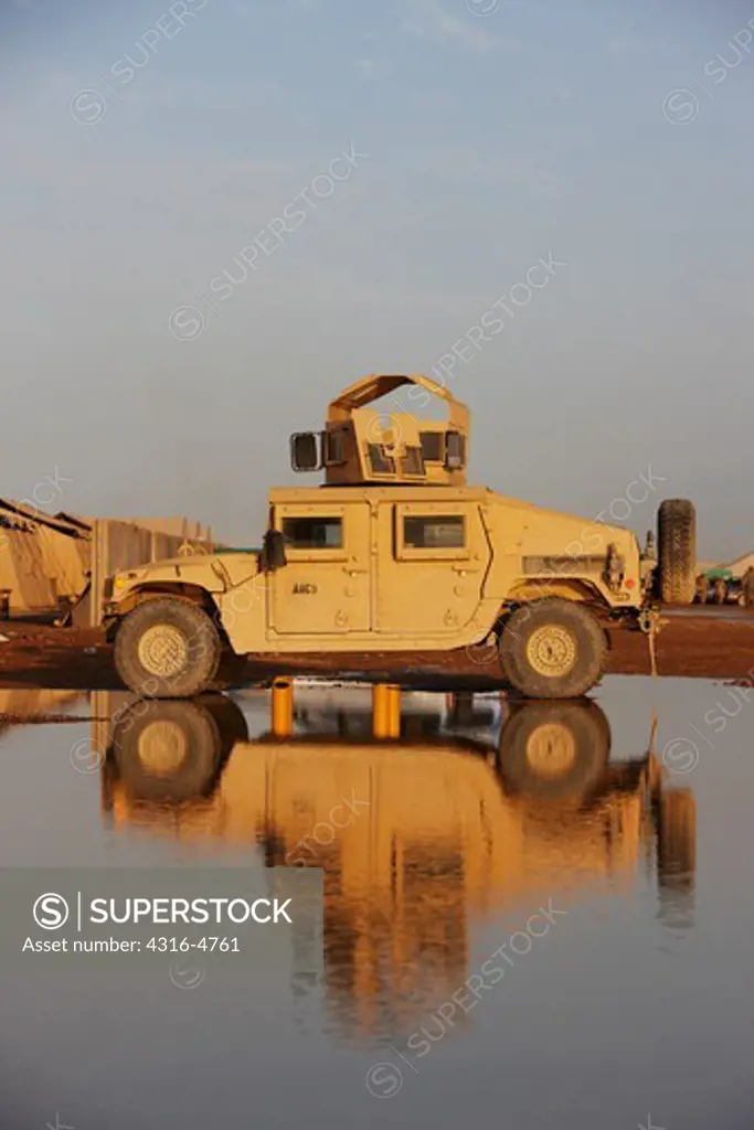 HMMW, or Humvee, parked on a puddle in Afghanistan's Helmand Province