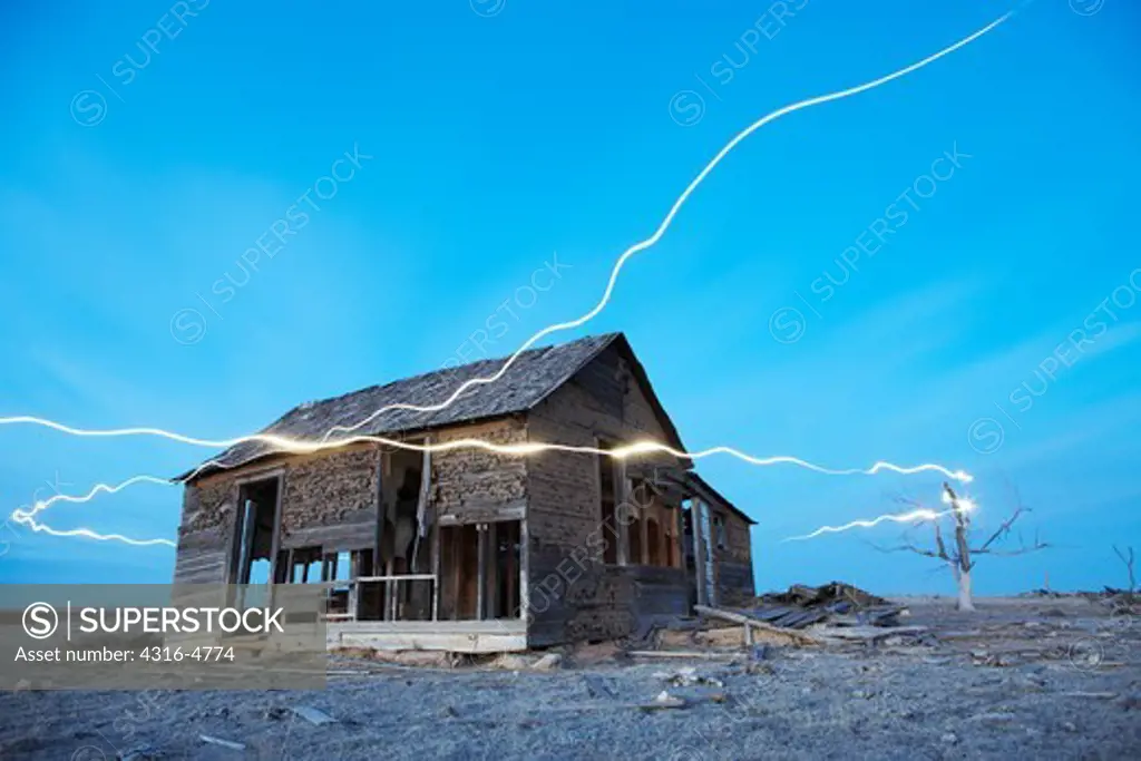 Abandoned, decaying ranch house on plains, encircled by ""ghost lights,"" Colorado