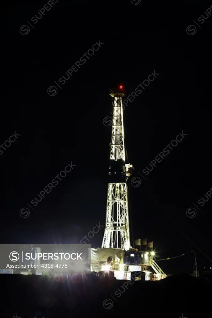 Night view of a natural gas drilling rig, Colorado