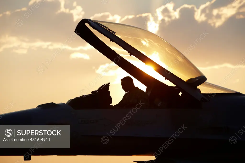 Silhouette of pilot in cockpit of an F-16 Fighting Falcon while on ground