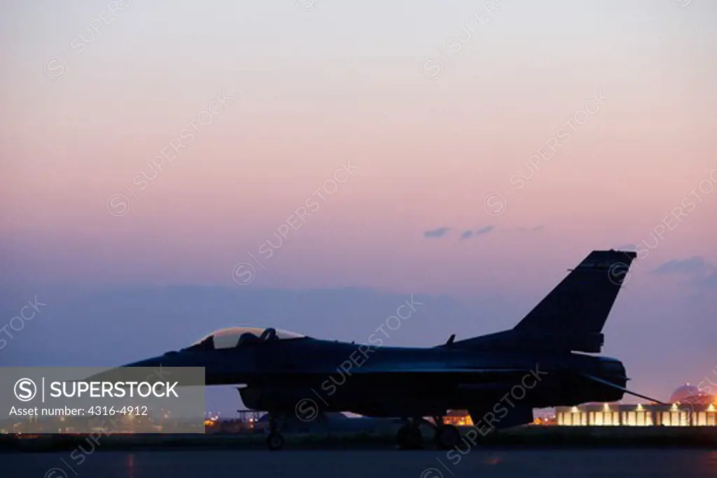 F-16 on runway at dusk