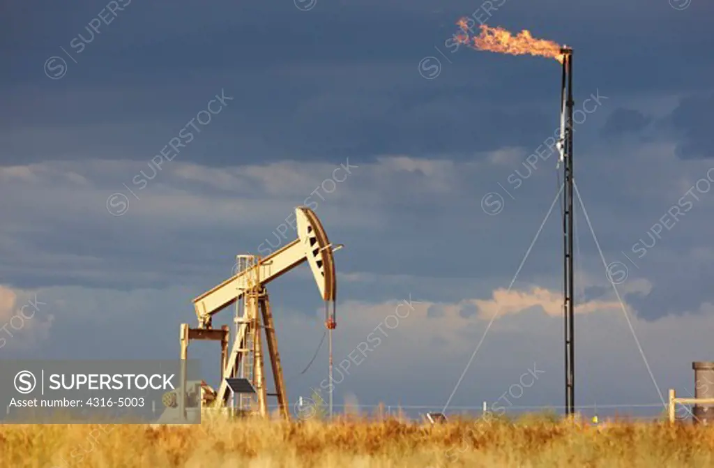 An Oil Well Pump Jack and Natural Gas Flare Tower