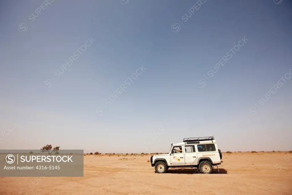 Land Rover in open desert, near Erg Chegaga, Morocco