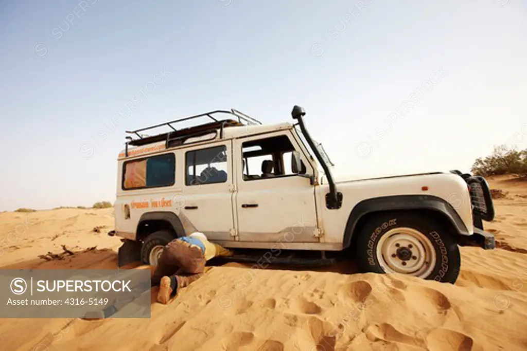 Digging out a Land Rover stuck in sand, Erg Chegaga, interior Sahara Desert, Morocco